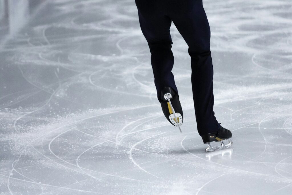 a man is skating on an ice rink